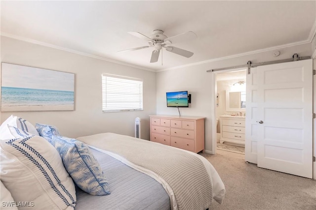 carpeted bedroom featuring ensuite bathroom, sink, ornamental molding, ceiling fan, and a barn door