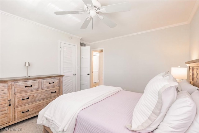 carpeted bedroom with crown molding and ceiling fan