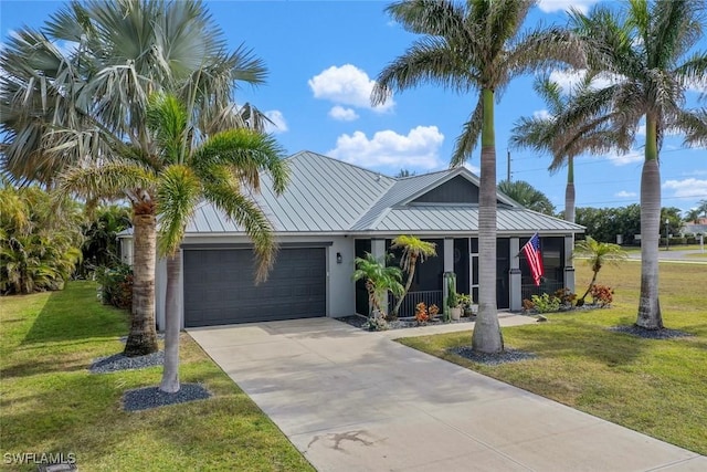 view of front of home featuring a front yard and a garage