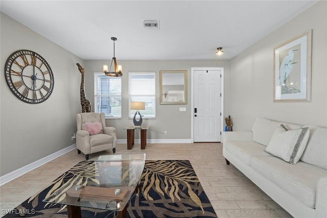 living room with light wood-type flooring and an inviting chandelier