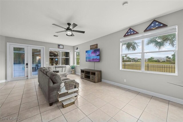 living room featuring french doors, ceiling fan, and light tile patterned flooring