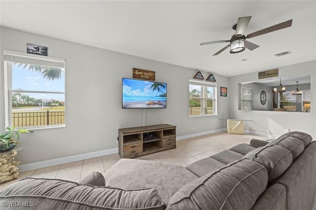 tiled living room featuring ceiling fan