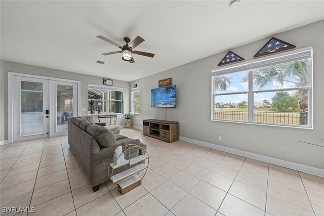 living room featuring ceiling fan, light tile patterned floors, and french doors