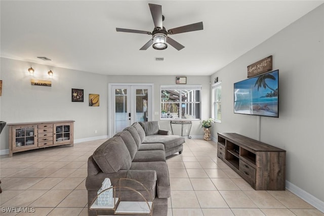 tiled living room featuring ceiling fan and french doors