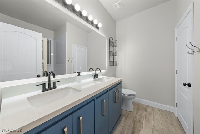 bathroom featuring hardwood / wood-style floors, toilet, and vanity