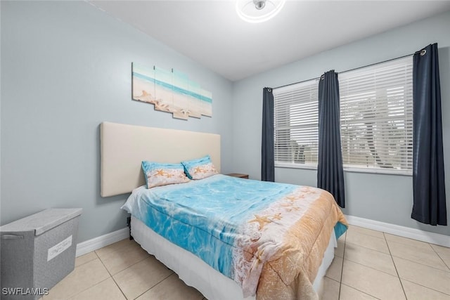 bedroom with light tile patterned floors