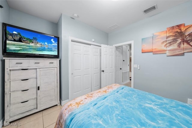 bedroom with light tile patterned flooring and a closet