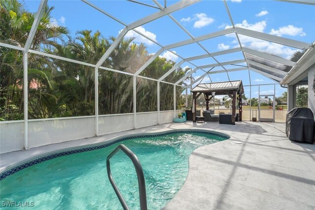 view of swimming pool with a lanai, an outdoor living space, area for grilling, and a patio