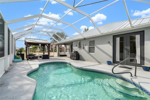 view of swimming pool with a patio, area for grilling, an outdoor hangout area, glass enclosure, and french doors