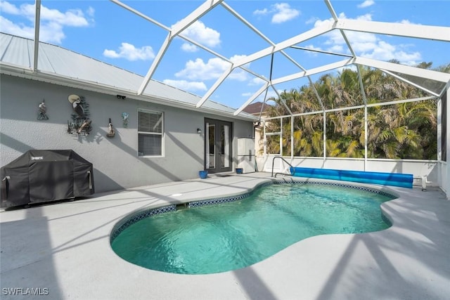 view of swimming pool featuring a patio, grilling area, and a lanai