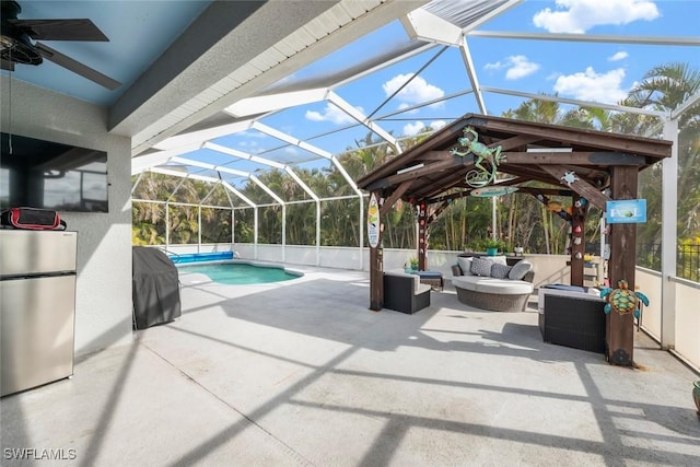 view of pool featuring a patio area, outdoor lounge area, ceiling fan, a lanai, and grilling area