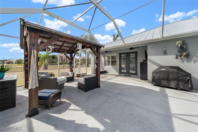 view of patio / terrace featuring ceiling fan, french doors, grilling area, a lanai, and outdoor lounge area