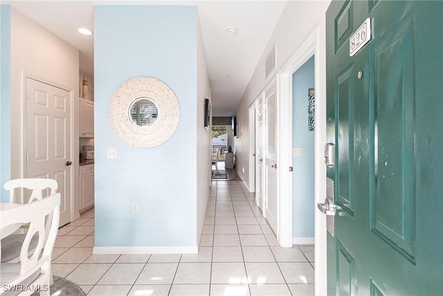 corridor featuring light tile patterned floors