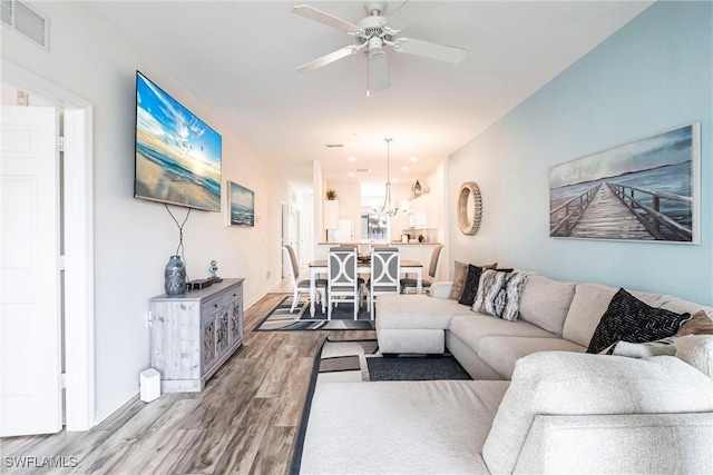 living room featuring hardwood / wood-style flooring and ceiling fan