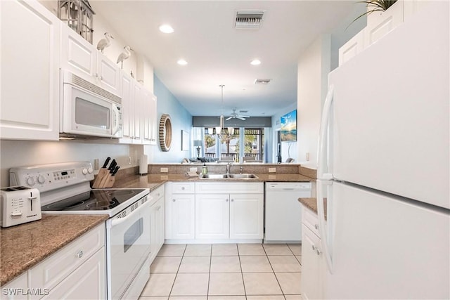 kitchen with white appliances, white cabinets, sink, kitchen peninsula, and light tile patterned flooring