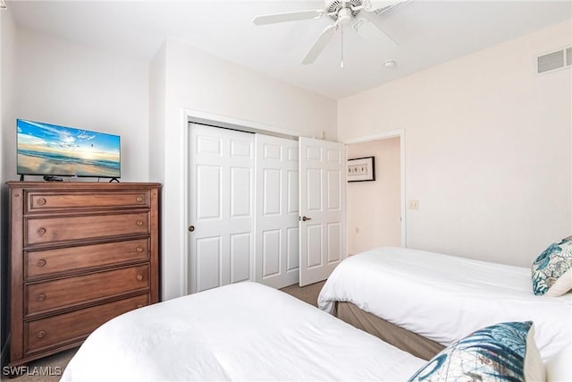 bedroom with a closet, ceiling fan, and carpet floors