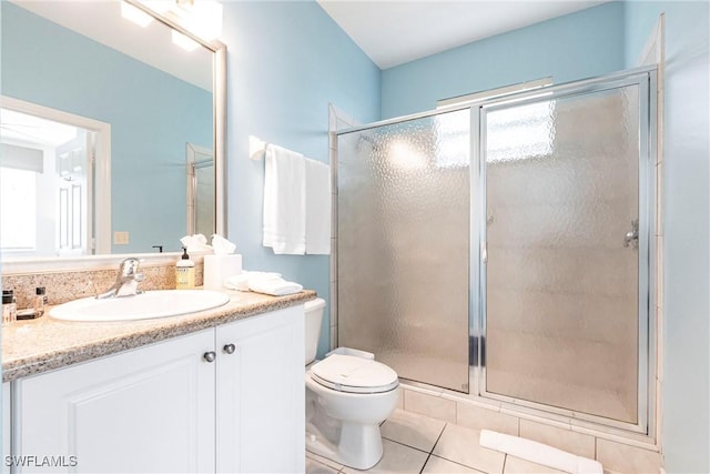 bathroom featuring vanity, toilet, tile patterned floors, and a shower with door