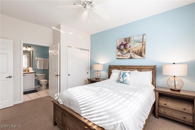 bedroom featuring ceiling fan, light carpet, a closet, and ensuite bathroom