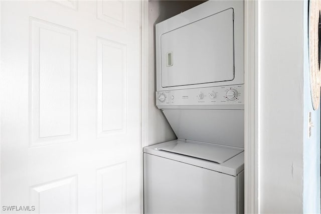 laundry area with stacked washer and dryer