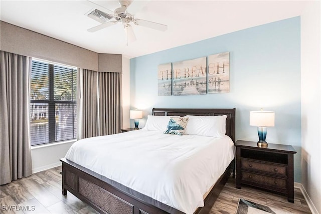 bedroom with ceiling fan and hardwood / wood-style flooring