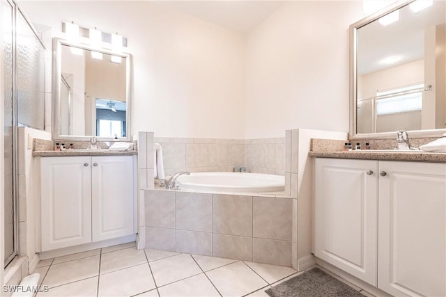 bathroom with vanity, a wealth of natural light, tile patterned floors, and separate shower and tub