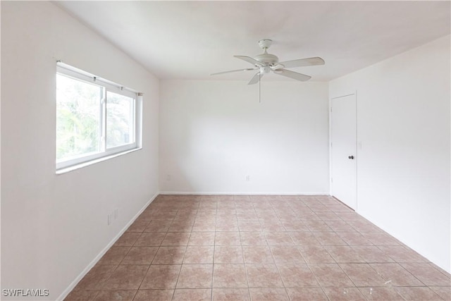 unfurnished room featuring ceiling fan and light tile patterned floors