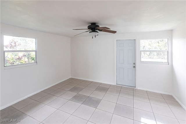 unfurnished room with ceiling fan, plenty of natural light, and light tile patterned floors