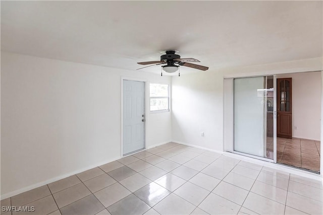 empty room featuring light tile patterned floors and ceiling fan