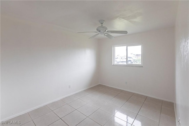 spare room with light tile patterned floors and ceiling fan