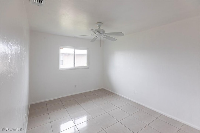 unfurnished room featuring light tile patterned flooring and ceiling fan