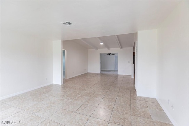 tiled empty room with ceiling fan and beamed ceiling