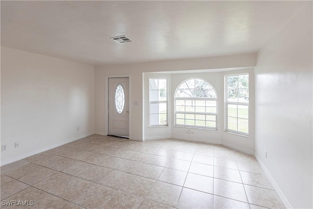 entryway featuring light tile patterned floors and plenty of natural light