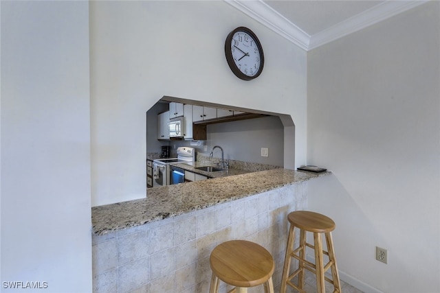 kitchen featuring crown molding, sink, light stone counters, white appliances, and a breakfast bar area