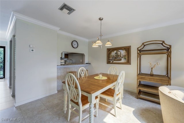 dining area featuring sink and ornamental molding