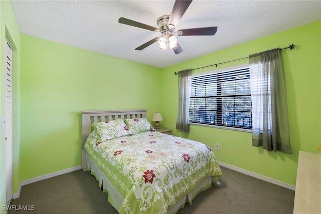 carpeted bedroom with ceiling fan, a textured ceiling, and a closet