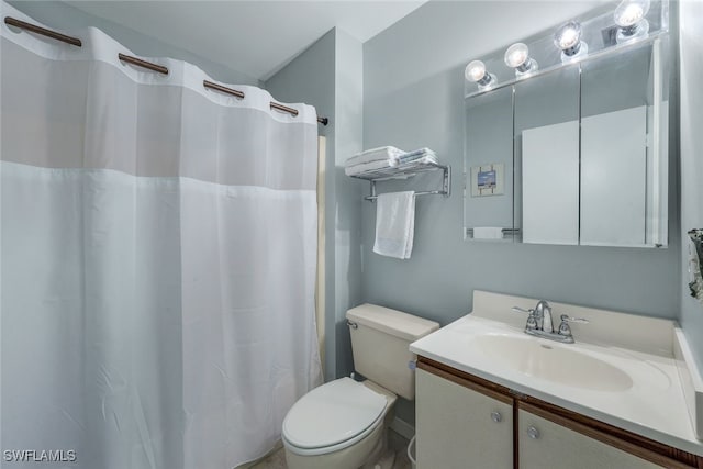 bathroom with toilet, vanity, and a shower with shower curtain