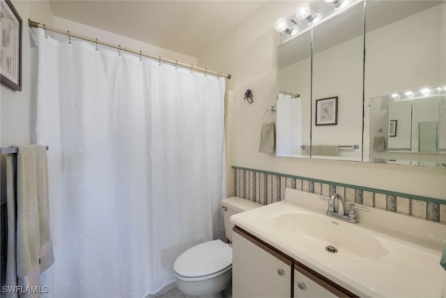 bathroom featuring toilet and vanity