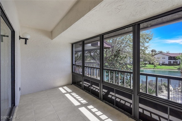 sunroom / solarium featuring a water view