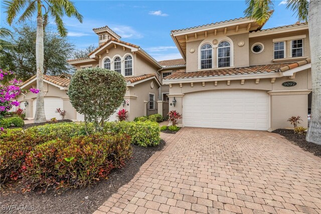 mediterranean / spanish-style house with a garage