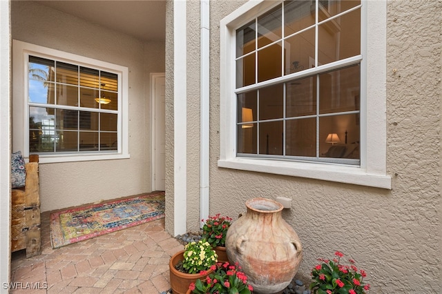 view of exterior entry featuring stucco siding