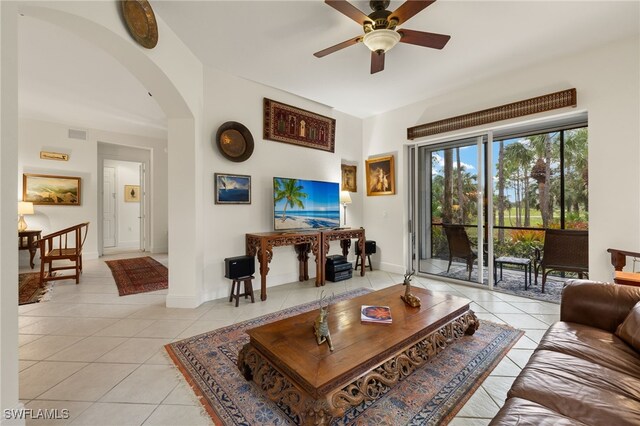 tiled living room with ceiling fan