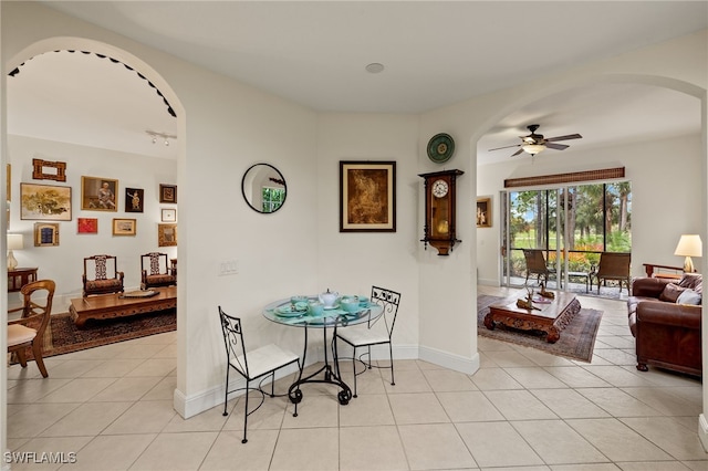 tiled dining space featuring ceiling fan