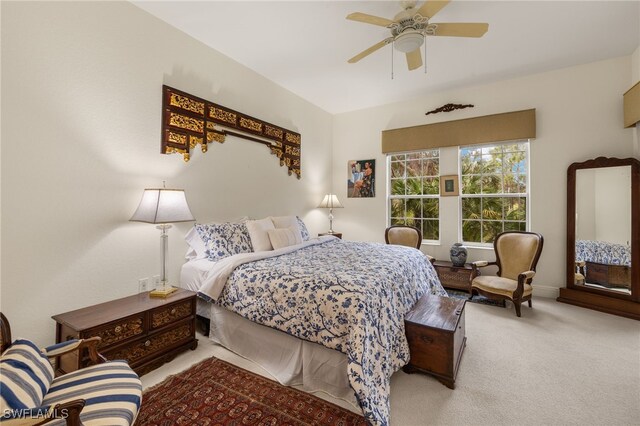 bedroom with ceiling fan and light colored carpet