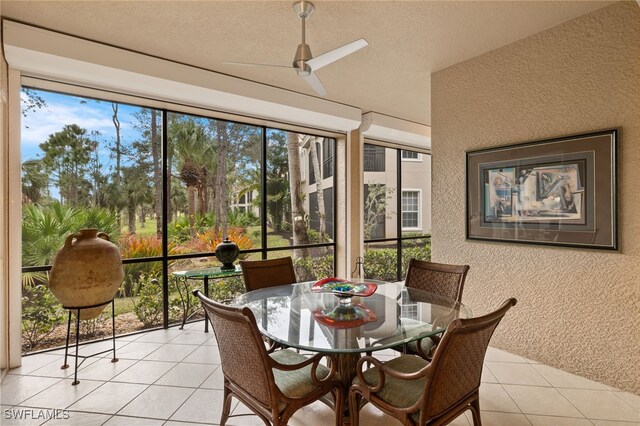 sunroom / solarium featuring a healthy amount of sunlight and ceiling fan