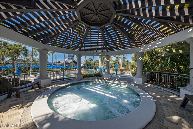 view of pool featuring an in ground hot tub