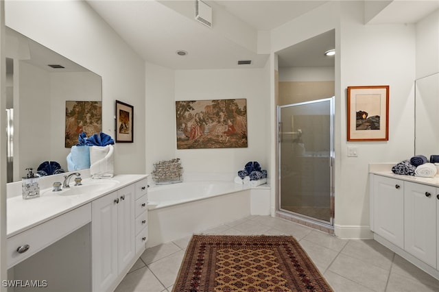 bathroom featuring tile patterned flooring, vanity, and shower with separate bathtub