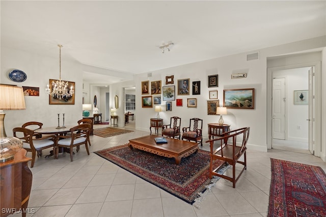 living room featuring light tile patterned flooring and a notable chandelier