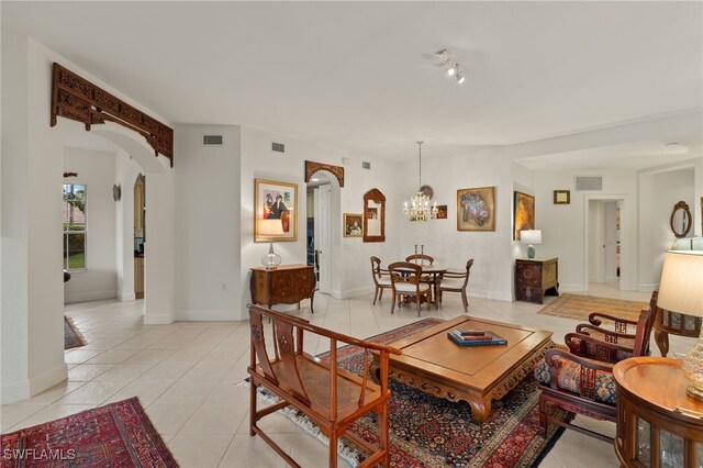 living room featuring an inviting chandelier and light tile patterned floors