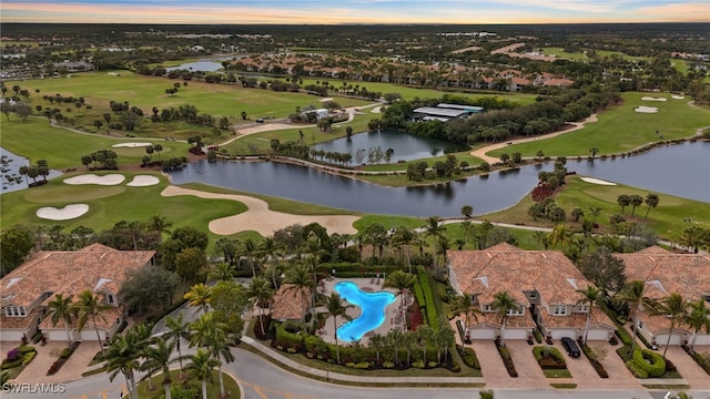 drone / aerial view featuring a water view and golf course view