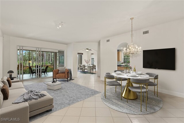 dining area featuring light tile patterned flooring and a notable chandelier